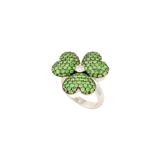 A four-leaf clover ring featuring green gemstones in a pavé setting on a silver band, centered on a plain white background.